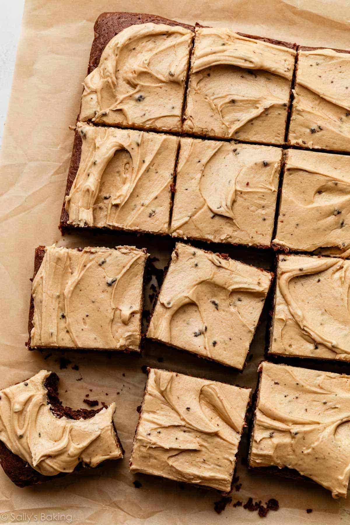 frosted Guinness brownies on brown parchment paper.